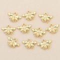 Macro view of ten gold-plated bee charms with zircon stones for DIY jewelry making - Gold Bee