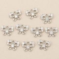Macro shot of 10 silver butterfly charm connectors with zircon stones for DIY jewelry - Silver Bowknot Style