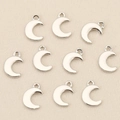 Detailed view of ten silver crescent moon pendants for DIY jewelry making on fabric - Silver Moon Shape