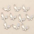 Macro view of butterfly charms with silver finish and pavé cubic zirconia for DIY jewelry - Silver Butterfly Style