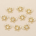 Macro shot of 10 gold plated bow-shaped pendants with micro-pave cubic zirconia stones - Gold Bowknot Style