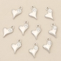 Macro view of 10 heart charms in silver finish with sparkling zircon inlays - Silver Heart with Single Stone (Style 4)