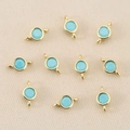 Close-up of sky blue round zircon charms with 18k gold plated double loops for DIY jewelry - 3mm / Gold Turquoise