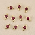 Detailed macro view of 10 round red gemstone charms with 18k gold-plated double jump rings - 3mm / Golden Red