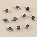 Macro shot of circular blue zircon pendants with silver connectors for DIY jewelry making - Silver Blue
