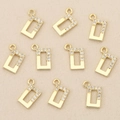Macro shot of rectangular 18k gold plated charms with white cubic zirconia inlay - Gold Hollow Rectangle (Style 9)