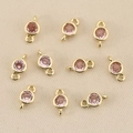 Macro shot of 18k gold-plated double-loop pendants with pink faceted birthstones for DIY jewelry - Gold Pink