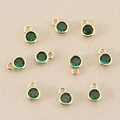 Macro detail of ten gold-plated round pendants with green zircon for DIY jewelry making - 3mm / Gold Green