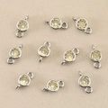 Close-up of 18k gold plated round birthstone charms for DIY jewelry making and pendants - Silver Yellow