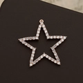 Elegant 18K gold-plated star pendant with white zircon pavé on a dark leather surface - Rose Gold