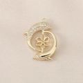Detail of a golden dolphin jewelry pendant with sparkling zircon micro-pave and flower base - Gold