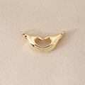 Detailed macro of 18K gold-plated heart hand gesture pendant with connector rings - Gold