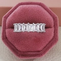 Macro view of rectangular cut cubic zirconia stones set in a silver eternity ring band - US 5 / White