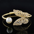 Gold open bracelet featuring a large white pearl and a zircon-encrusted butterfly - Gold Butterfly Pearl Style