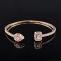 Macro shot of S925 rose gold bracelet with halo-set pear and rectangle cut crystals - Rose Gold Asymmetric Style
