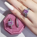 Detail of emerald cut pink gemstone ring set with micro-paved cubic zirconia accents - US 5 / Pink