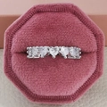 Macro shot of a silver heart-shaped eternity ring in a pink velvet jewelry box - US 5 / White