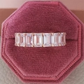 Macro view of emerald-cut white zircon eternity ring in rose gold on velvet gift box - US 5 / Rose Gold