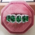 Detaillierte Makroansicht des Rings mit fünf ovalen grünen Edelsteinen in rosa Samtbox - Größe 5 / Grüner Halo Eternity Ring (R4574) / Grün