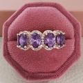 Rose gold ring with four oval purple stones and sparkling zircon accents on pink velvet - Size 5 / Oval Halo Style (R5390) / Purple