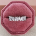 Close-up of a silver eternity ring with baguette-cut zircons in a pink velvet jewelry box - US 5 / White