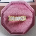 Detailansicht eines goldfarbenen Rings mit Baguette-Schliff-Zirkonia in rosa Samtbox - Gold