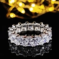 Elegant silver eternity ring with emerald-cut crystals and reflective base on black background - Size 5 / Large Emerald Cut Eternity White Style (r4816)