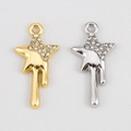 Macro detail of fluid star pendants in gold and silver finish with sparkling rhinestones - Meteor Design Star / Silver