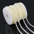 Macro shot of ivory ABS faux pearl beads string neatly wound on a spool for DIY jewelry crafts - Double Line Pearl / 6mm (10m Pack) / Off White