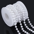 Detailed view of white faux pearl bead chain on a spool for DIY bridal and craft projects - Round Pearl / 6mm (10m Pack) / White