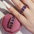 Detail of rose gold rings with oval purple stones in a pink velvet jewelry box - Purple