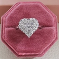 Top macro view of heart shaped silver ring with cubic zirconia in a pink velvet box - US 5 / Silver