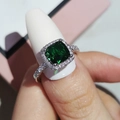 Macro shot of square cut green gemstone ring with halo diamonds on silver band - Size 5 / Green