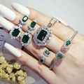 Luxury silver-tone 4-piece jewelry set with emerald-cut green stones worn by a model - Green (R6864-S5214-X6590-E6522-Green)