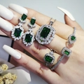 Detailed close-up of emerald style jewelry set with necklaces, rings and earrings - Green (R6644-S5214-X6590-E6522-Green)