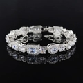 Detailed close-up of silver geometric bracelet with sparkling crystals on dark mirror surface - Mixed Cut Halo Inlaid Style (s7208)