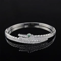 Silver crocodile bracelet with white zircons and green gemstone eye on black background - Silver Crocodile Style