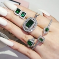 Luxury jewelry set with emerald green stones and diamond halo on model hand - Green (R6644-S5214-X6590-E6049-Green)