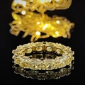 Eternity ring with oval yellow gemstones in golden claw setting and luxurious bokeh background - US 5 / Gold