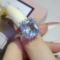 Elegant square blue sapphire halo ring with silver band for women shown on hand - US 5 / Blue