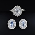 Macro shot of silver jewelry set featuring oval cubic zirconia in floral cluster design - White / Size 5