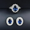 Macro shot of silver jewelry set with oval sapphire-blue stones and white crystals - Blue / Size 5