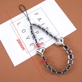 Detail view of handmade beaded phone strap with silver heart charms and black core beads - 1 Piece / Crystal Silver Heart