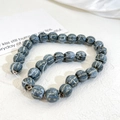 Macro shot of pumpkin shaped ceramic beads with retro kiln glaze texture for DIY jewelry - Blue