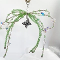 Handmade green crystal bead bow keychain with a silver butterfly pendant charm - Green