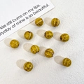 DIY pumpkin-shaped striped ceramic beads in amber marble finish for jewelry making - Yellow
