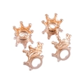 Detailed view of four small shiny gold crown charms for DIY handmade jewelry crafts - KC Gold
