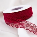 Detailed close-up of dark red lace ribbon with scalloped edges on a spool - 30mm-22m / Burgundy