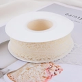 Close-up of cream white lace ribbon roll with intricate hollow scalloped edge details - 30mm-22m / Off White