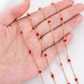 Golden 4mm copper chain with inlaid red glass crystals shown in palm for size scale - 0.5 Meters/Pack / Red